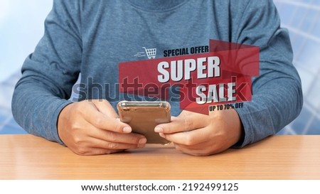 Young man using smartphone shopping online with SUPER SALE discount banner promotion, E-commerce business online. Shopping online concept.