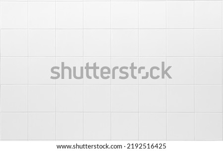white tiles wall in the office White tiled wall for bedroom, kitchen, bathroom and interior design. White tiled wall in clean and symmetrical textured background view with grid texture background Royalty-Free Stock Photo #2192516425