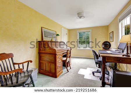 Light yellow office room with antique cabinet and desk