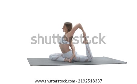 Young athletic attractive woman practicing yoga on white background.