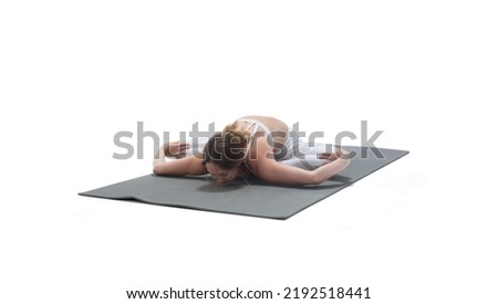Young athletic attractive woman practicing yoga on white background.