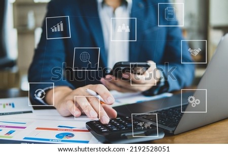 Business man working on desk with business icon on visual screen in concept of business idea and data global.