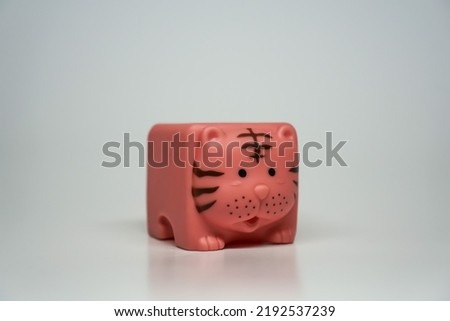 Children's toy in the form of a cube with a rubber material looks like a cat.
