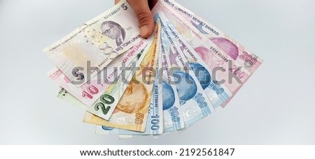 Two-handed Turkish coins (200-100 -50-20-10 Turkish Lira) on a white background Royalty-Free Stock Photo #2192561847