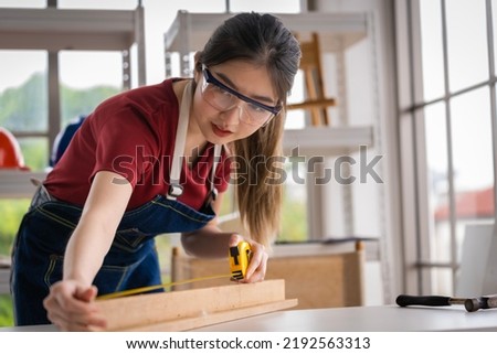 Bright and cheerful Asian female carpenter I'm designing furniture to decorate my own home. professionally