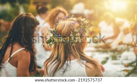 View of women making wreaths with beautiful flowers.
