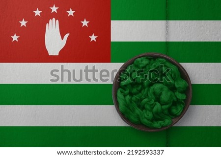 Wooden basket on background in colors of national flag. Photography and marketing digital backdrop. Abkhazia