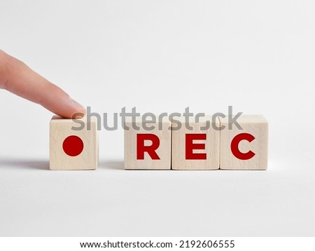 Finger presses the REC record button with the word rec on wooden cubes. Start recording concept.  Royalty-Free Stock Photo #2192606555