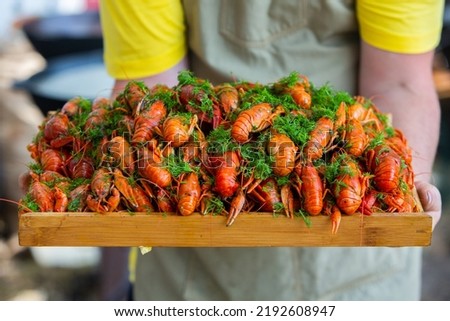 Boiled red crayfish or crawfish with herbs. Crayfish boiling in the pot on the fire.