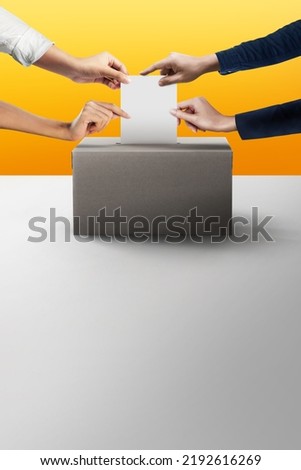 Election vote. Four hands holding ballot paper for election vote concept at yellow background.
