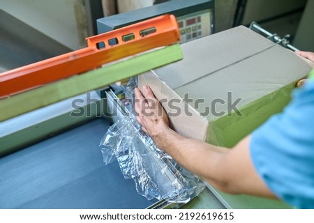 Skilled storehouse operator applying automated packaging system