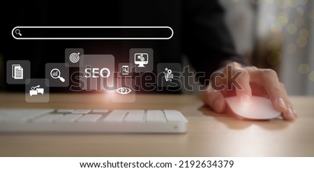 SEO, Search Engine Optimization ranking concept.  Digital marketing strategy of promote traffic to website. Working on computer with the icon of online search engine, abbreviation SEO and SEO symbol.  Royalty-Free Stock Photo #2192634379