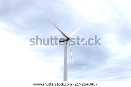 Aerial photo of a nice windmill in Thailand. with white clouds in the blue sky.