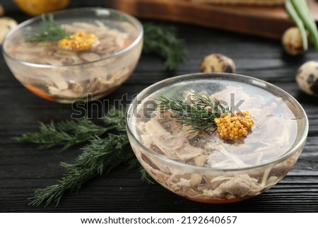 Delicious aspic with meat served on black wooden table
