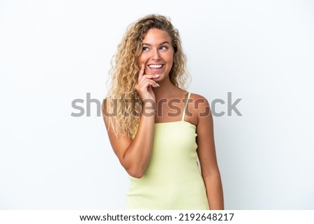 Girl with curly hair isolated on white background thinking an idea while looking up