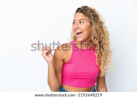 Girl with curly hair isolated on white background intending to realizes the solution while lifting a finger up