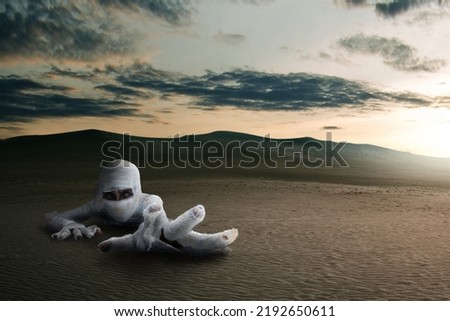 Mummy crawled with the desert background. Halloween concept
