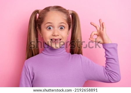 Portrait of young lovely little woman show okay symbol advertise promote product isolated on pink color background