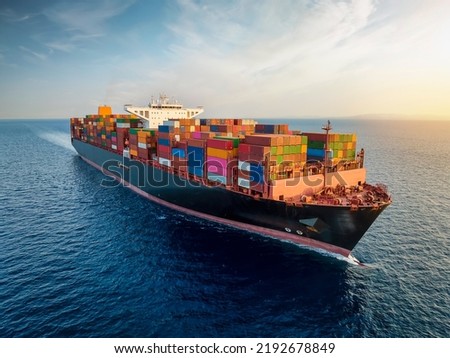 Aerial view of a large, loaded container cargo ship traveling over open ocean Royalty-Free Stock Photo #2192678849