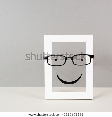 Frame with a happy face with eyeglasses, mental health concept, positive mindset and emotion, support and evaluation symbol