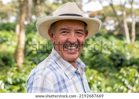 Portrait of an old Colombian peasant man wearing a hat and looking at the camera with a big smile. Royalty-Free Stock Photo #2192687669