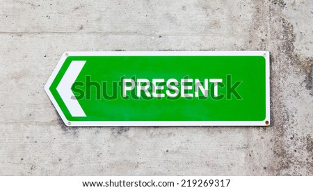 Green sign on a concrete wall - Present