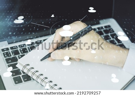 Double exposure of social network icons concept with hand writing in notebook on background with laptop. Marketing and promotion concept