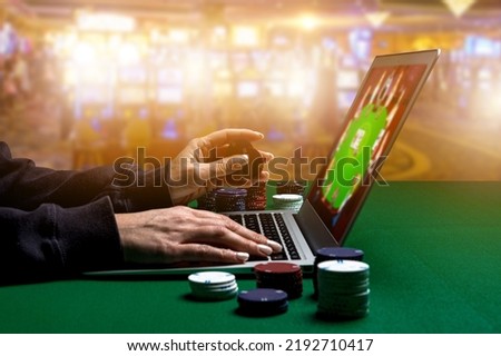 Woman hands with Gambling Chips using laptop for playing online casino. Concept virtual leisure activity. Royalty-Free Stock Photo #2192710417