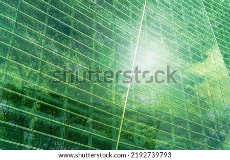 Sustainble green building. Eco-friendly building. Sustainable glass office building with tree for reducing carbon dioxide. Office with green environment. Corporate building reduce CO2. Safety glass. Royalty-Free Stock Photo #2192739793