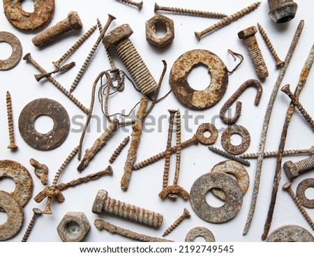 Different rusty screws, nuts, washers and bolts on a white background; top view; flat lay Royalty-Free Stock Photo #2192749545