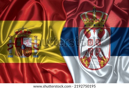 Spain and Serbia two folded silk flags together