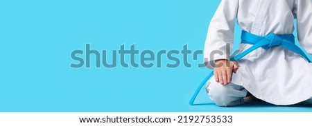 Little boy in karategi on light blue background with space for text Royalty-Free Stock Photo #2192753533