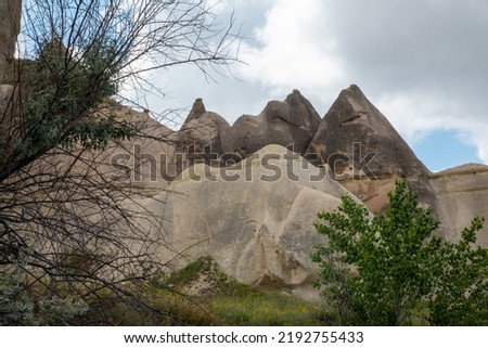 Fairy chimneys in Goreme valley in Cappadocia. And blue sky background.