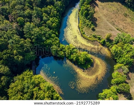 Aerial photograph of a drone flight over the Marghitas Lake.  Photo taken on 15th of August 2022, near Anina city, Caras-Severin County, Romania. Royalty-Free Stock Photo #2192775289