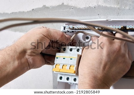 Electrical work to install new panel of electric distribution board consumer unit with fuse box or circuit breaker Royalty-Free Stock Photo #2192805849