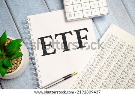 Word writing text ETF with calculator and chart. Business concept