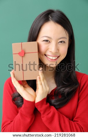 Young woman portrait hold gift in christmas color style .