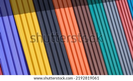 Diagonal pattern of multi colored Corrugated Metal Sheet for roofing on Display stand with sunlight and shadow on surface Royalty-Free Stock Photo #2192819061