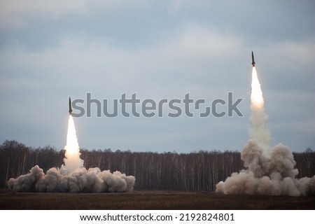Launch of military missiles (rocket artillery) at the firing field during military exercise Royalty-Free Stock Photo #2192824801