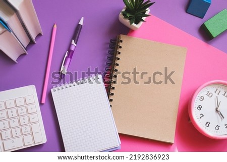 Back to school concept photography. Table top view image. Book, computer keyboard, paper notebook, pen, pencil, alarm clock on a desk