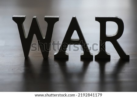 a word war laid by wooden letters dollar banknotes background