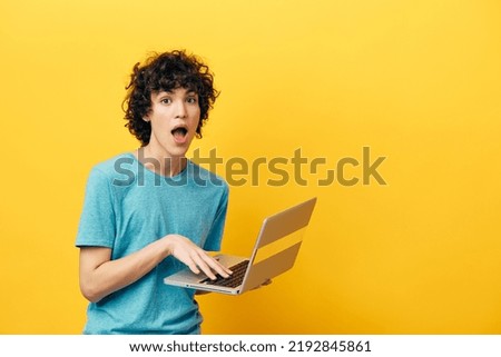 freelancer in blue t-shirts with laptop internet yellow background