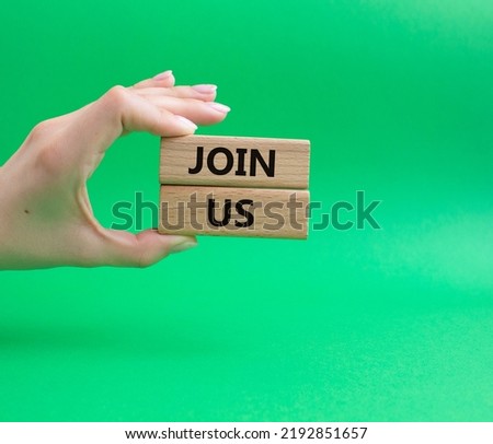 Join us symbol. Concept word Join us on wooden blocks. Beautiful green background. Businessman hand. Business and Join us concept. Copy space