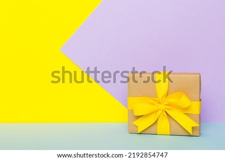 holiday paper present tied yellow ribbon bow top view with copy space. Flat lay holiday background. Birthday or christmas present. Christmas gift box concept with copy space. Royalty-Free Stock Photo #2192854747