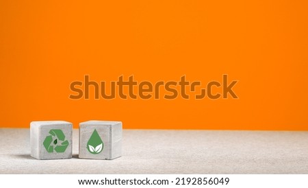 The concept of environmental protection. concrete cube with green economy icons, energy sources. copy space. green energy