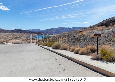 View of low water level at Lake Mead, Nevada in 2022 with sign showing where it was in 2002. Royalty-Free Stock Photo #2192872043