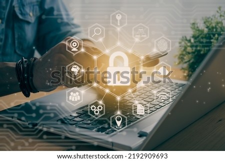 Casual Businessman Hand Touching Mobile Phone or Smart Phone Screen and Hexagon Lock Security Sign and Laptop Computer. Secure or Firewall and Protection Concept in Vintage Tone