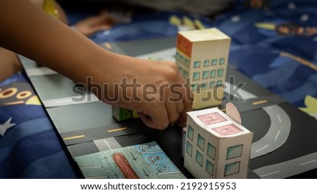 Children's hands are building cities in 3D modeling. Concepts about the city