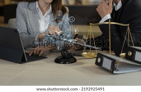 Lawyer meeting and lawyer working on table office with digital law interface icons, law and justice concept.