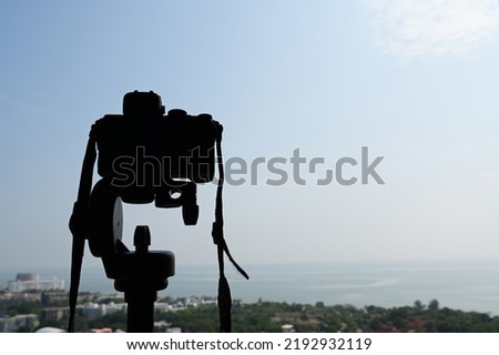black digital camera shooting city landscape